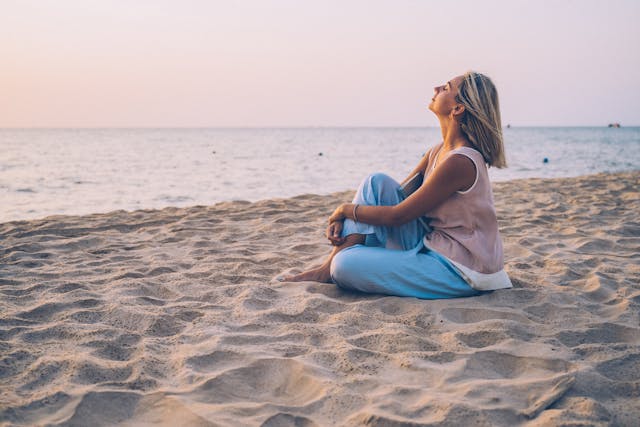 a-blonde-woman-relaxing-on-the-beach