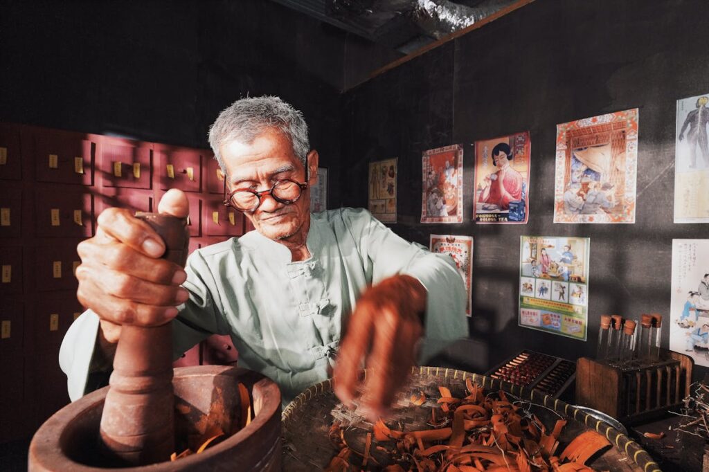Ancient Healing practitioner preparing traditional Chinese herbal medicine at West End Organix