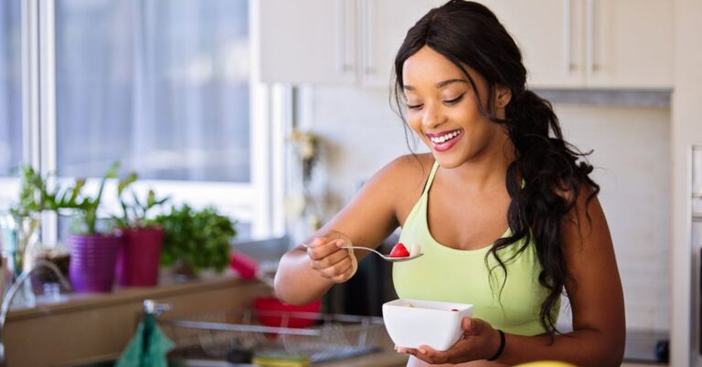 Plant-based weight loss morning routine with woman eating fruit to reset her body clock naturally.