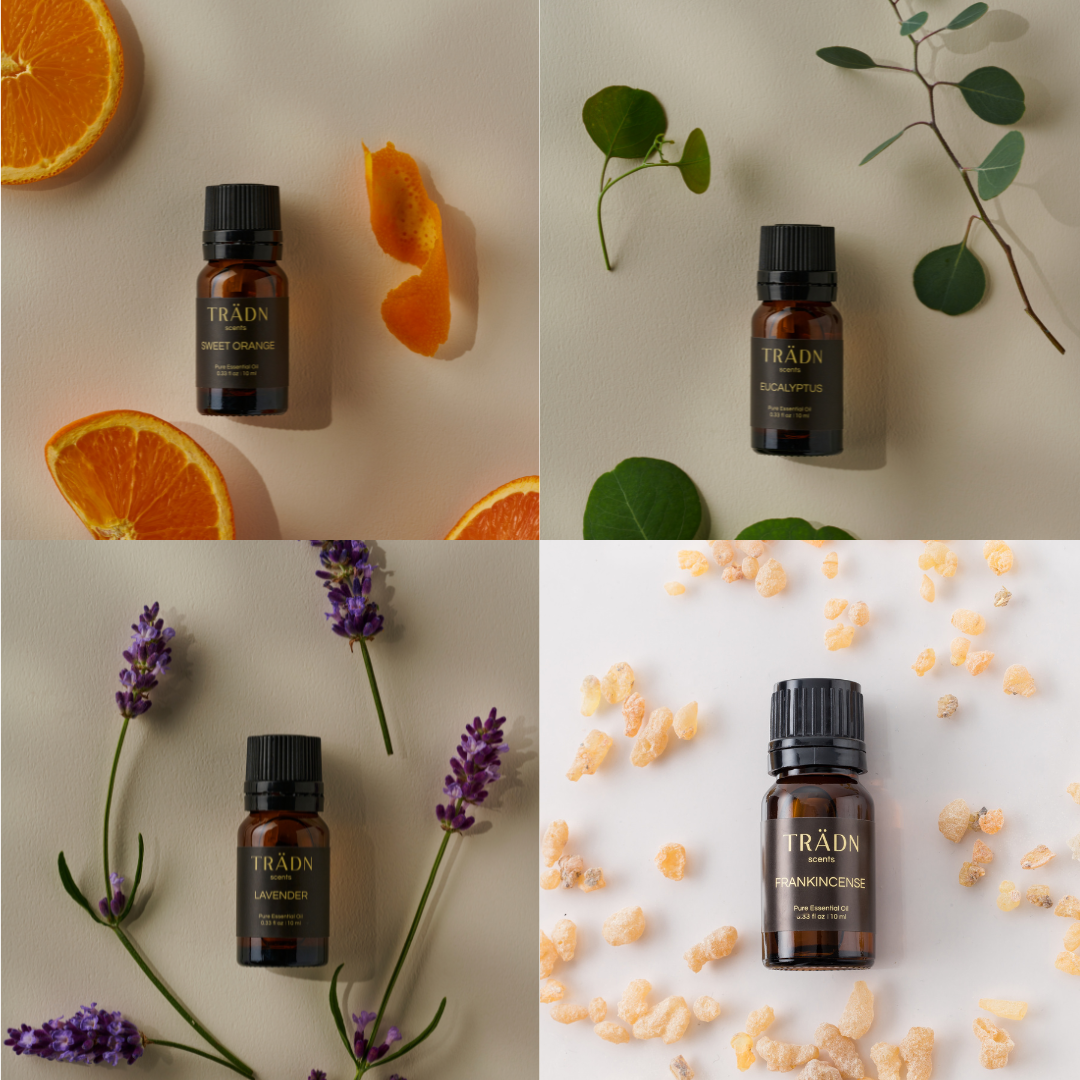 TRÄDN Essential Oils Sweet Orange, Eucalyptus, Lavender, and Frankincense in a natural aromatherapy flatlay – 100% pure essential oil gift set.